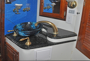 The vanity raised washbasin also has a gold plated fawcet and taps.
