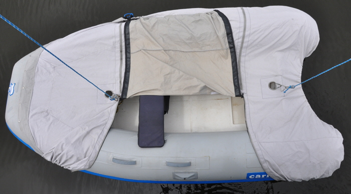 A flap in the dinghy makes it much easier to fit the cover then climb up the boaring ladder.