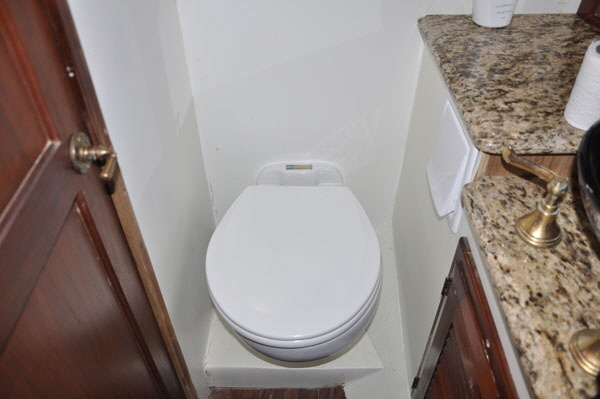 The new Raritan Elegance electric toilets have a full size seat and are many times more efficient than the old hand pumped heads.