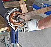 Pulling the rotor out of the stator using a wooden lever to break the strong magnetic hold.