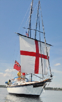Britannia is drifting along downwind under her fore-course alone.