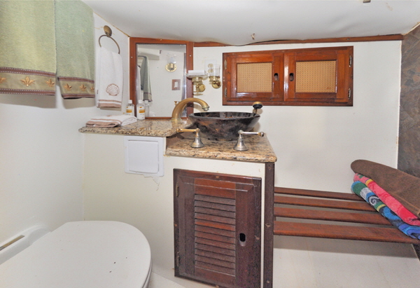 The forward bathroom was completely remodeled with a shower and electric toilet. The washbasin sits on marble slabs.