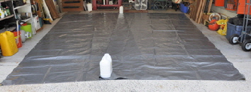 Making the tarp laid out in a garage.