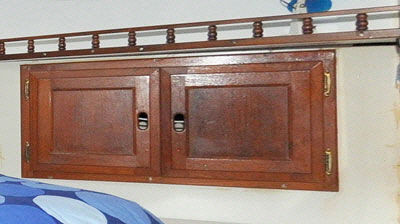  The old doors were re-used on the sides of the bed with shelves inside.