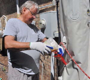 Pouring the foam into the dinghy chamber.